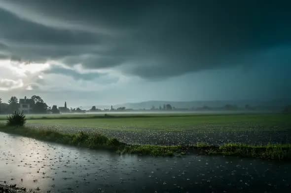 Dramatic Rainstorm Sweeps Across Misty Rural Landscape