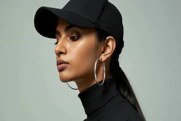 Fashionable Indian Woman in Black Cap and Earrings