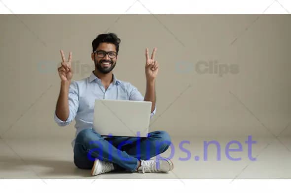 Smiling Man with Laptop Showing Peace Sign