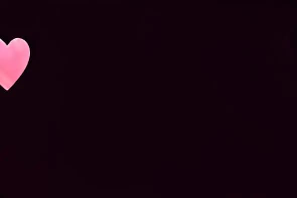Single Soft Pink Heart Floating on Dark Background Animation