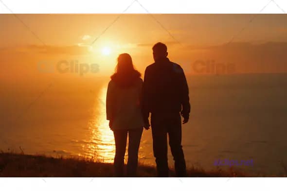 Couple Watching Sunset Over Ocean