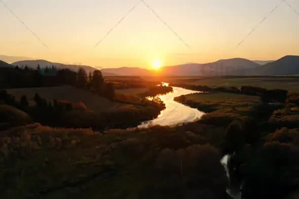 Aerial View of Sunset Over Serene River Valley