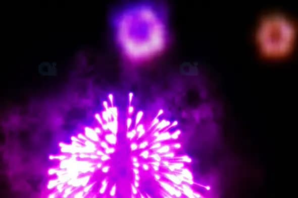 Vivid Pink and Purple Fireworks with Orange Bursts in Night Sky