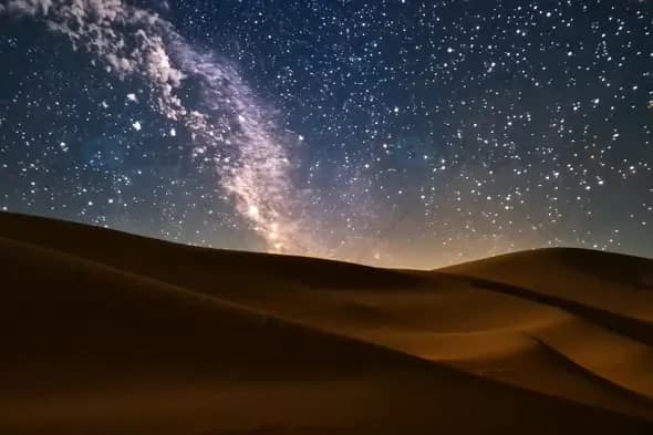 Starry Night Sky Over Desert Sand Dunes with Milky Way