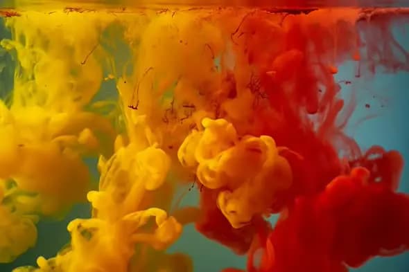 Colorful Ink Diffusion in Water with Red and Yellow Swirls on Blue Backdrop
