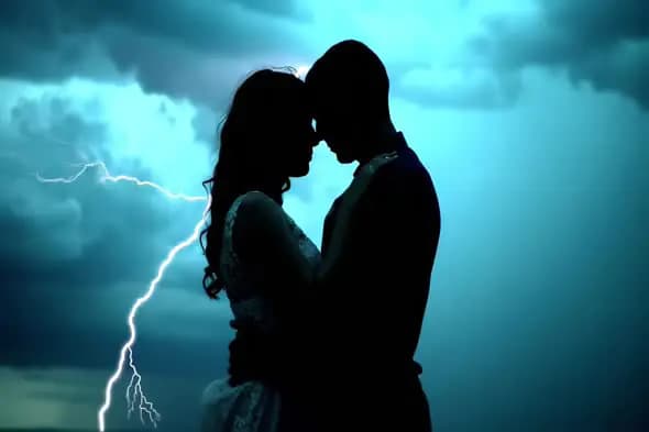 Romantic Couple Silhouette with Lightning Strike in Stormy Sky