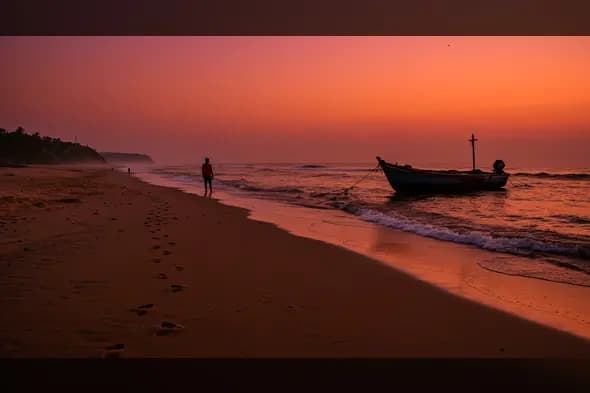 Indian Man Walking on the Beach at Sunset with Traditional Fishing Boat – Serene Coastal Landscape