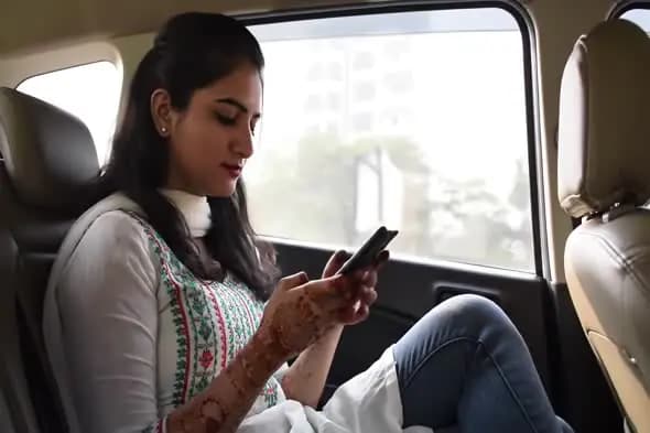 Commuter in Traditional Attire Using Smartphone