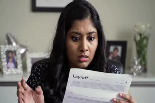 Shocked Employee Reading Layoff Notice