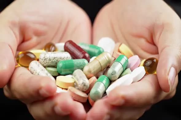 Diverse Medication Assortment in Cupped Hands