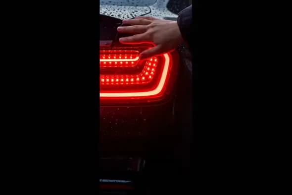 Sleek Car Taillight in Rainy Night