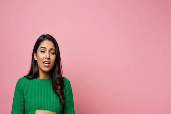 Indian Woman Expressing Dialogue on Pink Background