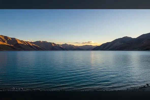 Tranquil Mountain Lake at Dusk with Clear Blue Waters