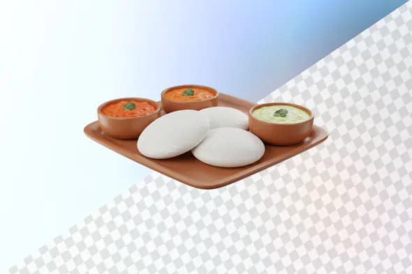 Idli with colorful chutneys on terracotta plate