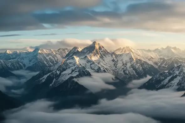 Majestic Snow Capped Mountain Peaks Above Clouds