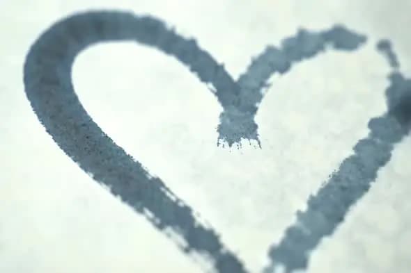 Heart Shape Drawn with Ink Bleed on Textured White Paper Background