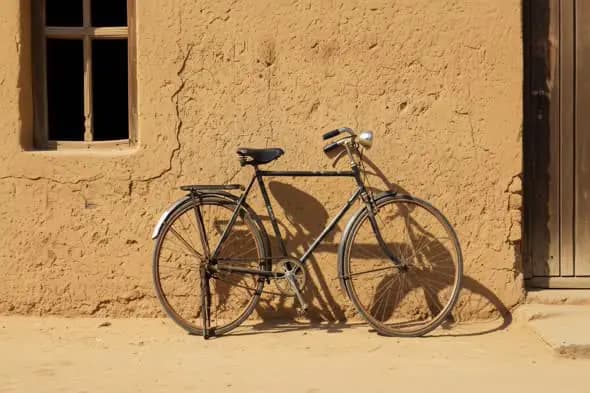 Vintage Bicycle Outside a Mud House Wall in Indian Village