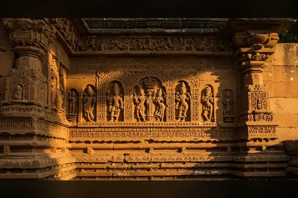 Ancient Temple Wall with Sculptures | Sunlit Indian Heritage Carvings