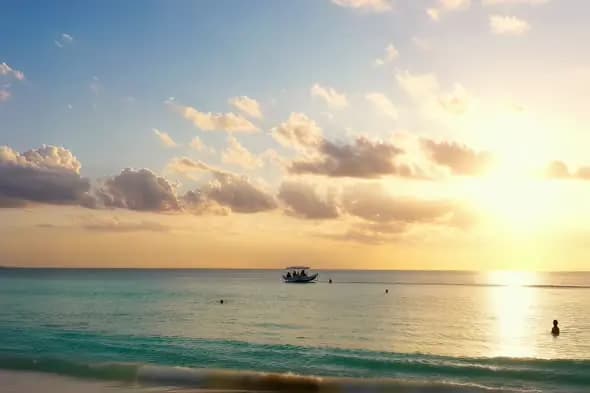 Tranquil Tropical Beach Sunset Boat Ocean Scenery