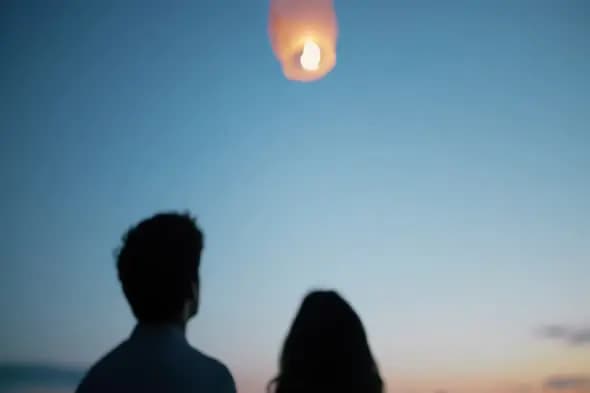 Couple Watching Sky Lantern at Sunset