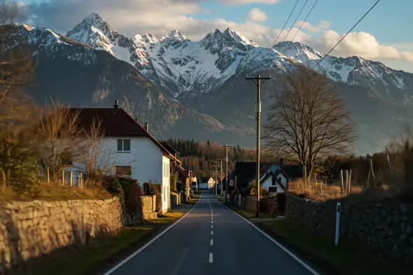 Alpine Village Road with Snowy Peaks