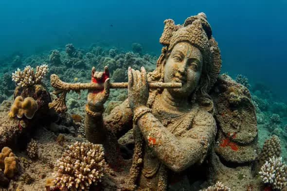 Submerged Krishna Statue in Coral Reef Underwater Scene