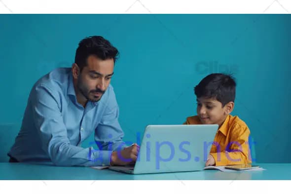 Father Helping Son with Laptop
