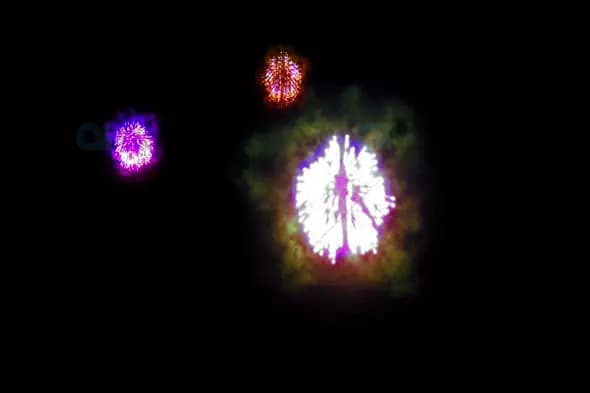 Triple Fireworks Burst with Purple, Orange, and White Explosions