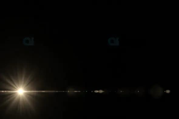 Horizontal Light Flare with Radiant Beams on Dark Background