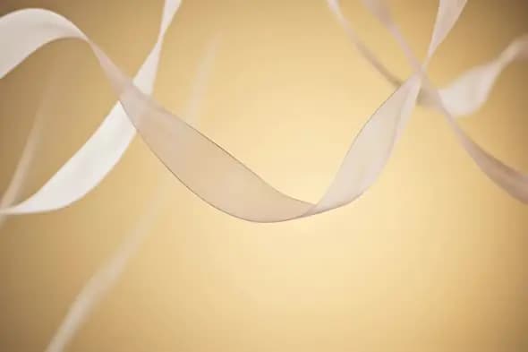 Elegant Flowing Ribbons on Golden Background for Luxury Celebrations
