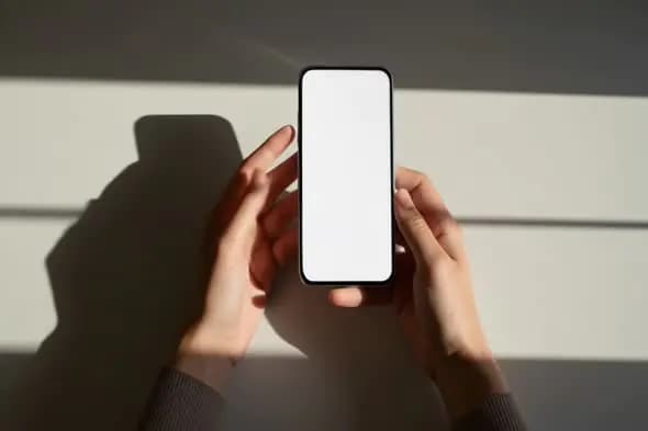 Hands Holding Modern Smartphone in Shadows