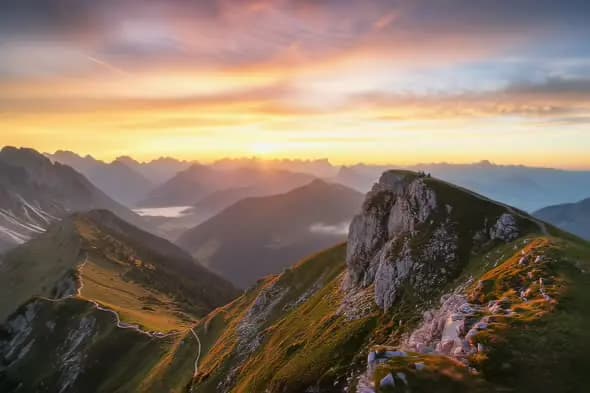 Majestic Alpine Sunrise Illuminates Rugged Mountain Landscape