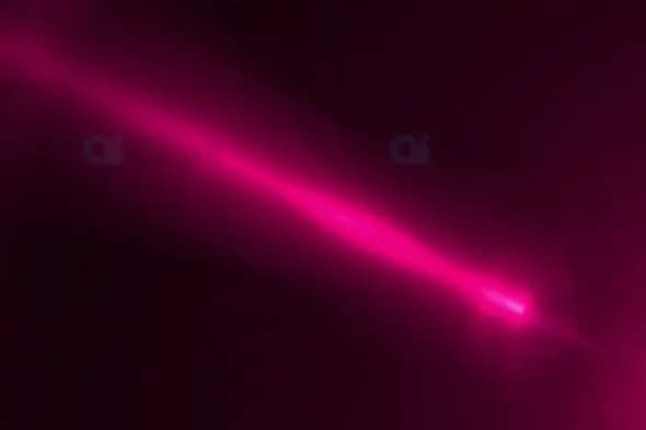 Bright Pink Laser Light Beam on Dark Background