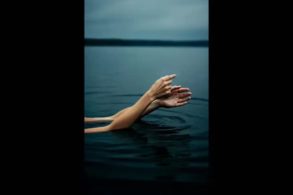 Artistic Hands Floating Gracefully in Tranquil Water