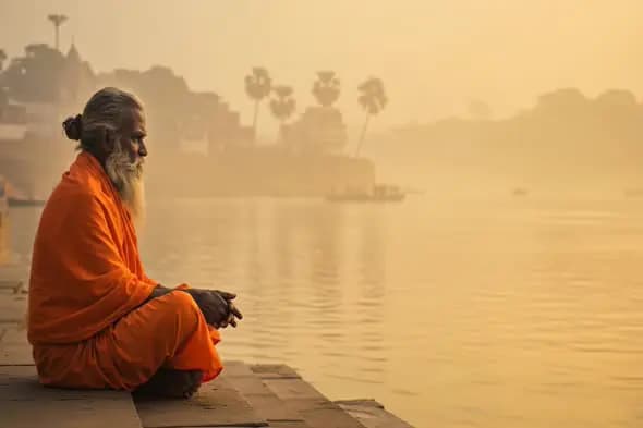 Spiritual Indian Sadhu by River Ganga at Sunrise Meditation in Varanasi