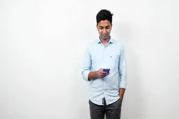 Professional Using Smartphone Against White Background