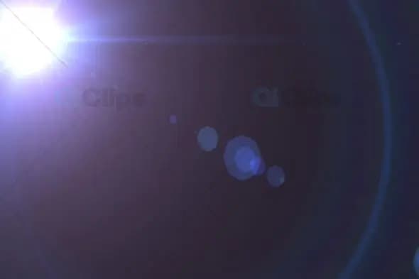 Bright Lens Flare Effect with Circular Bokeh on Dark Background