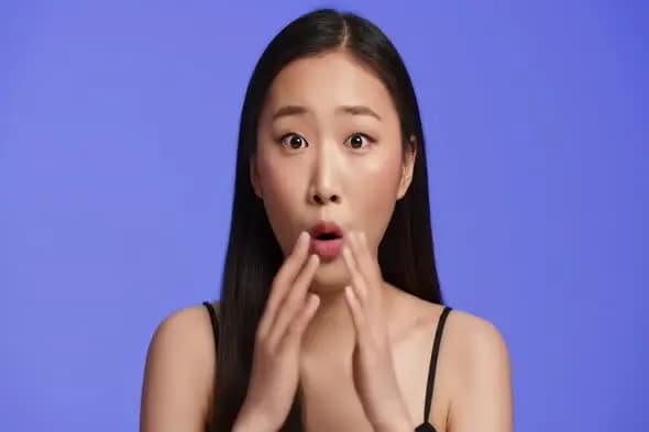 Surprised Expression with Hand Gesture on Purple Background