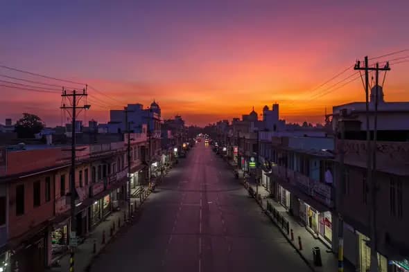 Vibrant Urban Sunset Illuminating Quiet City Street Scene