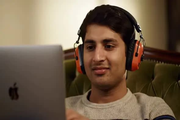 Focused Laptop User with Noise-Cancelling Headphones