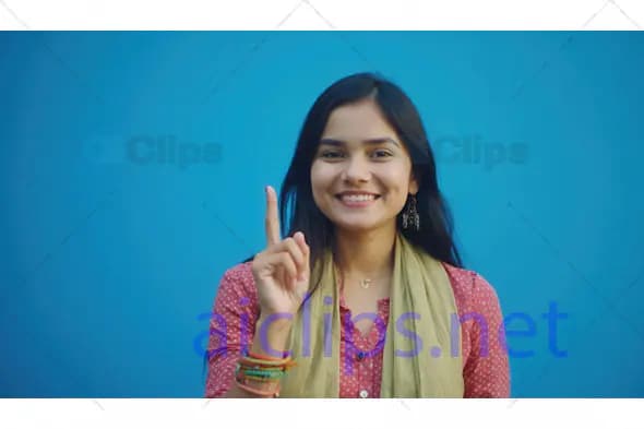 Young Woman Smiling and Pointing Up
