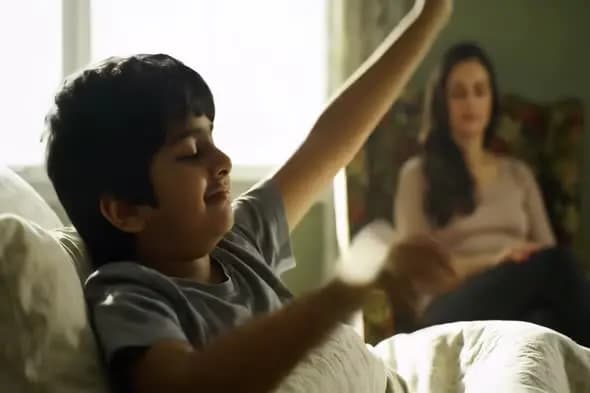 Joyful Child Stretching in Bed