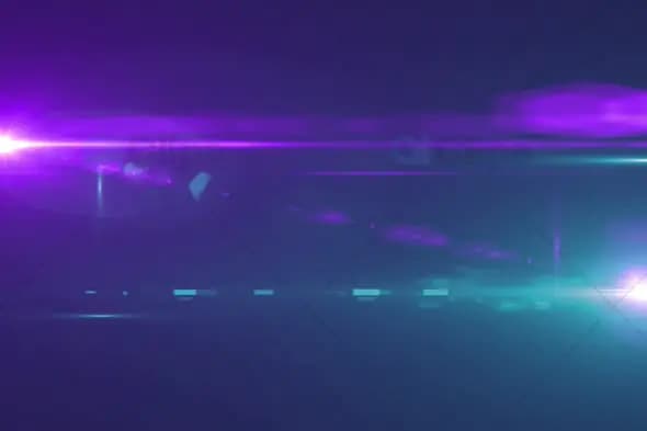 Purple and Teal Light Flare with Lens Streaks on Dark Background