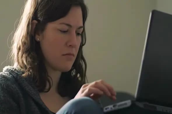 Focused Woman Using Laptop