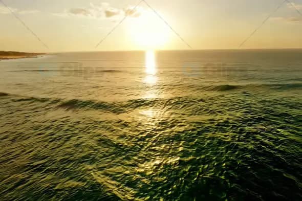 Golden Sunset Over Calm Ocean with Gentle Waves