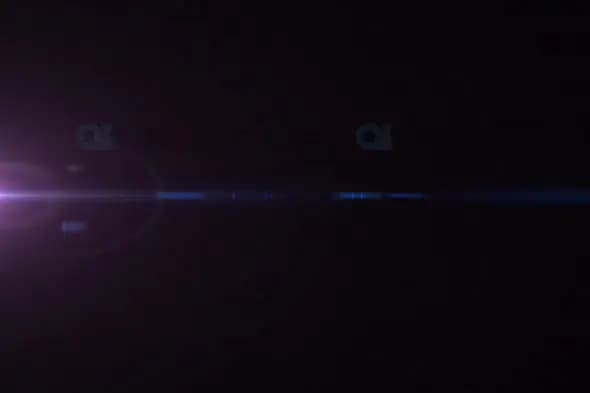 Subtle Purple and Blue Light Flare Across Dark Background