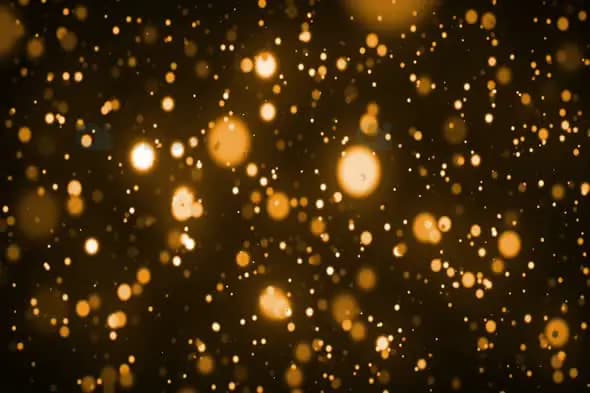 Warm Golden Bokeh Particles Floating in Dark Background