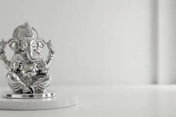 Silver Ganesha Statue on White Pedestal