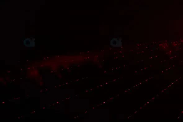 Grid of Red Laser Beams in Dark Atmospheric Scene