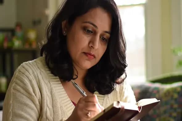 Focused Woman Writing in Journal